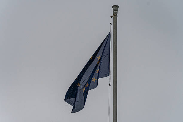 istock Clear sky, EU flag, rectangular shape, three stars, celestial symbols, Islamic design, crescent and sun motif, pole, daytime, vibrant colors, no clouds, no obstructions 2217530098
