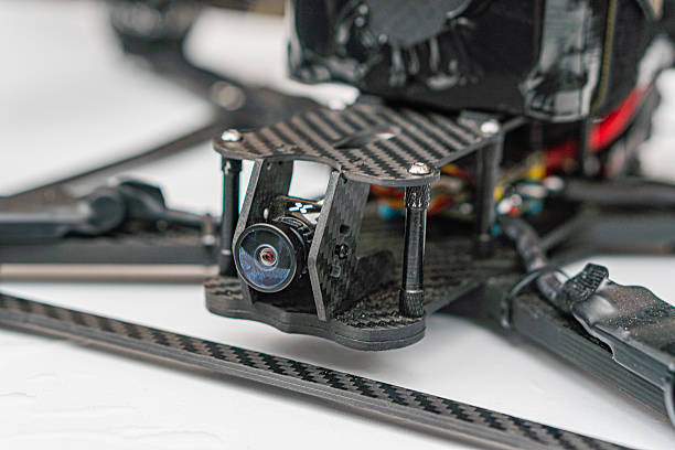 istock Close-up of combat quadcopter drone with exposed components, showcasing textured frame, electronic parts, camera assembly, and lenses Indoor setting with artificial lighting 2217531153