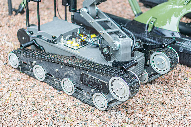 istock Robotic demining device, multiple articulated arms, rocky terrain or simulation setup, metallic color scheme, even lighting, technical photograph style 2217531633