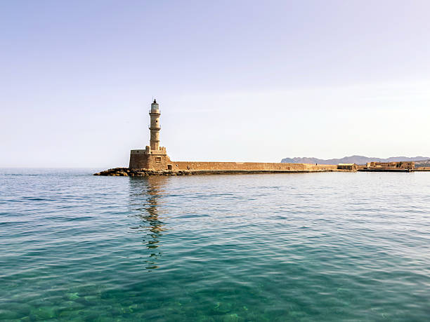 Chania Crete. Lighthouse at old venetian port, blue sky and calm sea