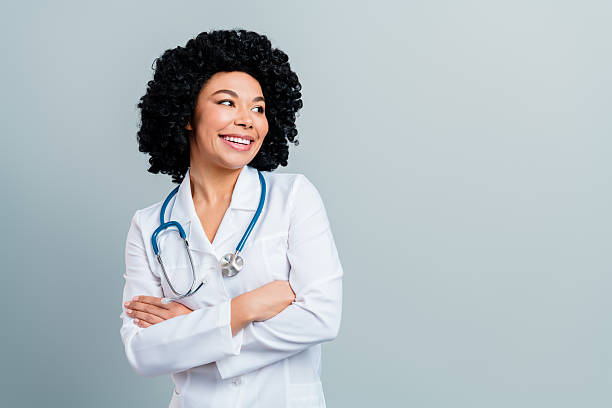istock Confident smiling female doctor in a white coat with stethoscope on neutral background for medical and healthcare concept 2217536246