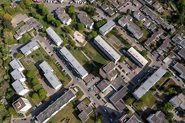 Aerial view of a large residential neighborhood with apartment buildings, streets and trees.