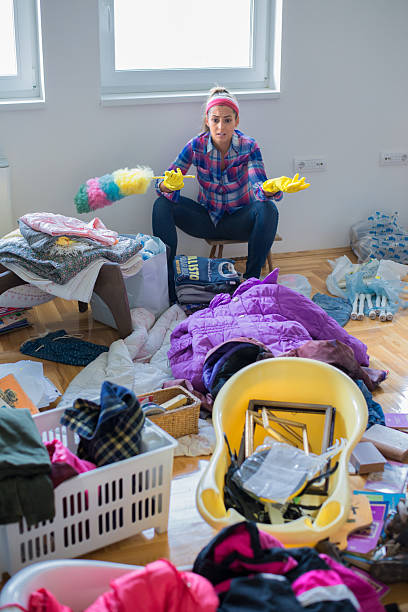 istock Young, angry woman sitting before house cleaning 2217542539