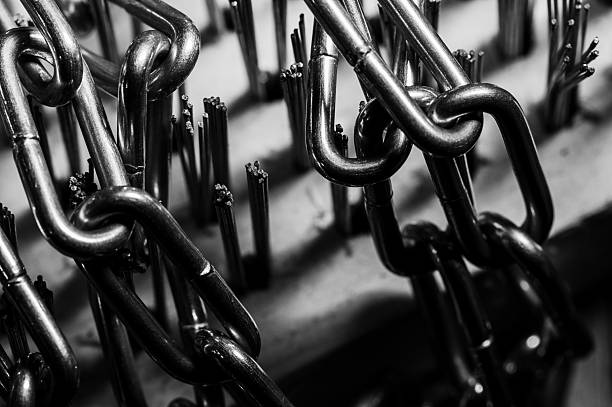 Overhead shot of defocused stacked long silver chain texture background.
