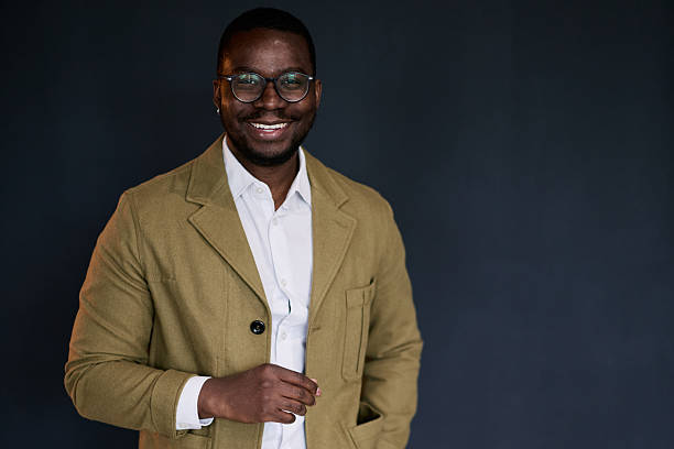istock Smiling Young Adult Black Man Posing in Studio with Dark Background 2217544281