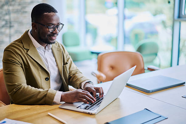 istock Young businessman typing on laptop in modern office 2217544307