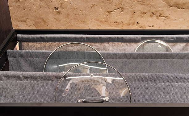 istock Glass pot lids stored vertically in fabric kitchen drawer 2217545137