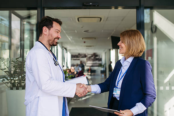 istock Confident female medical sales representative introducing herself to doctor. 2217545170