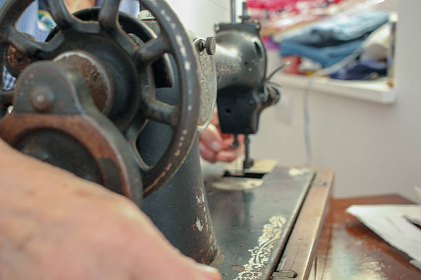 istock an old woman is working with an old sewing machine 2217545386