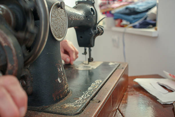 istock elderly woman working with her old sewing machine 2217545401