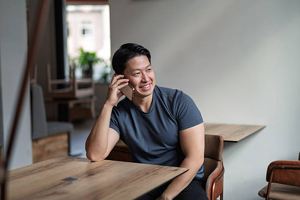 istock Confident man having phone call at cafe table. 2217546636