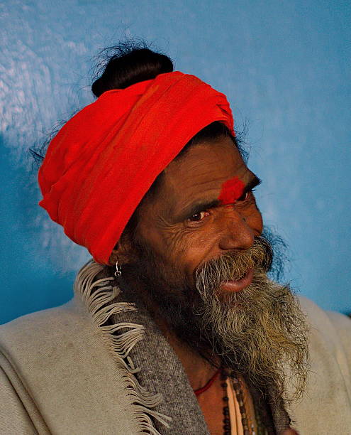 Bomdila, India. February 04, 2016. A pilgrim in a red turban and bright clothes is resting before another trip to Indian shrines.