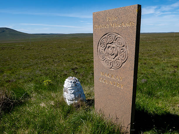 1st July 2021: One of six Mackay Country stone markers, with a Celtic design and gold coloured lettering. This one is located in Forsinard, with others located in the area of Caithness and Sutherland, in northern Scotland. They were put up in 2004 to welcome visitors to what was historically the territory of Clan Mackay.