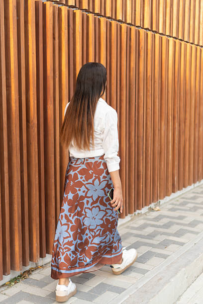 istock Young woman walking on the sidewalk with acne scars 2217547834