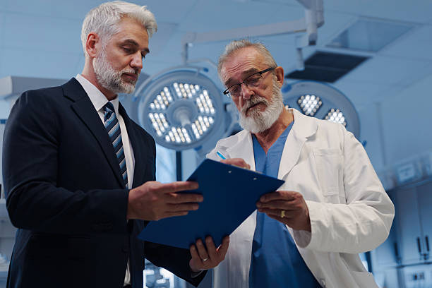 istock Doctor signing contract with pharmaceutical representative. 2217548467