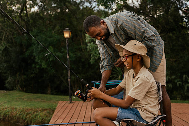 istock Father helping son with fishing 2217550235
