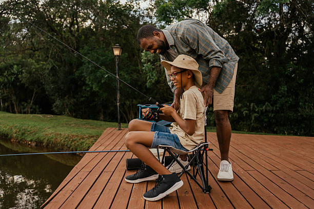 istock Father helping son with fishing 2217550237