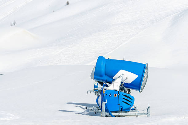 Close up a snow cannon along a ski run in the Swiss Alps on a sunny early spring day. Bernina Pass, Switzerland.