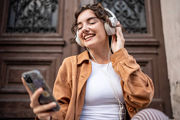 istock Young Woman Enjoying Music With Headphones Outdoors While Smiling 2217552885