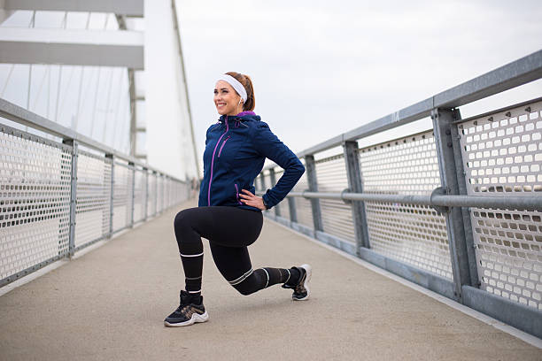 istock Young smiling woman exercising on the bridge 2217554324