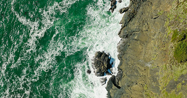 Drone shot of the Pacific Ocean and the coast-side cliffs of Otter Rock, OR. Shot during the day in Lincoln County Oregon.