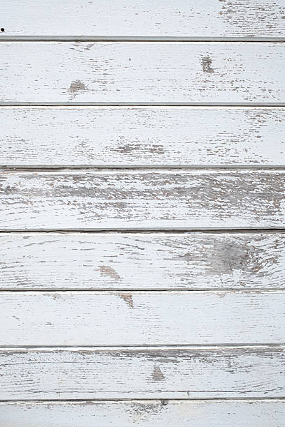 istock Rustic charm: Weathered wooden planks painted white showcasing a textured and distressed surface with flaking paint Vintage appeal 2217559591