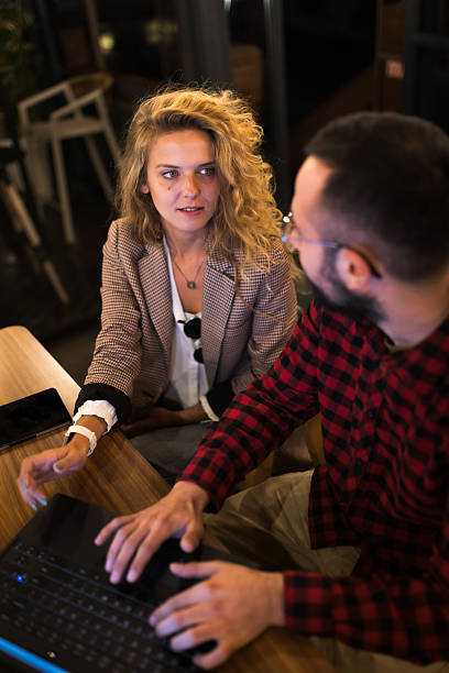 istock Collaborative discussion between young colleagues working on a laptop in a modern office setting 2217561832