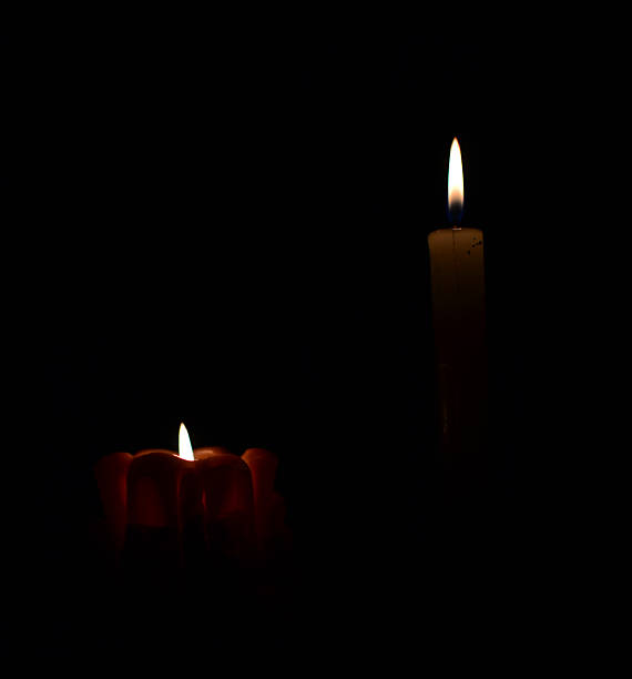 istock Two candles burning brightly in the dark. Represents hope, memory, or a quiet moment of reflection. Use for spiritual, holiday, or atmospheric designs. 2217562103