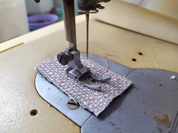 istock Closeup of a vintage sewing machine stitching fabric. Illustrates craftsmanship, tailoring, repair, or DIY projects. Evokes nostalgia and the art of sewing. 2217562177