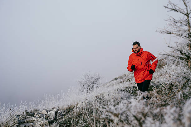 istock Man Climbing Rocky Hill in Fog 2217566796
