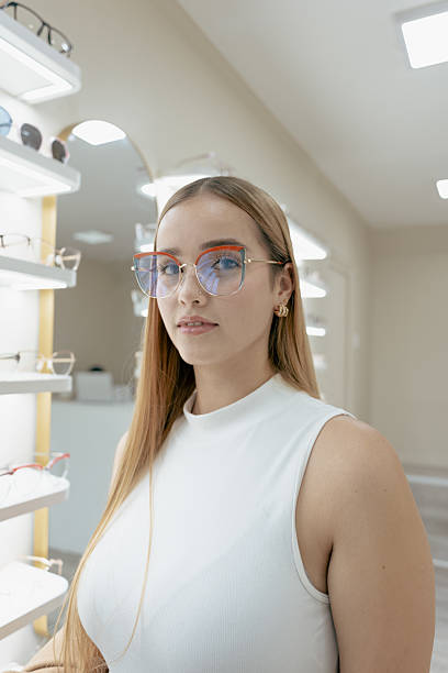 istock Young woman modeling eyeglasses in modern optical store 2217567446