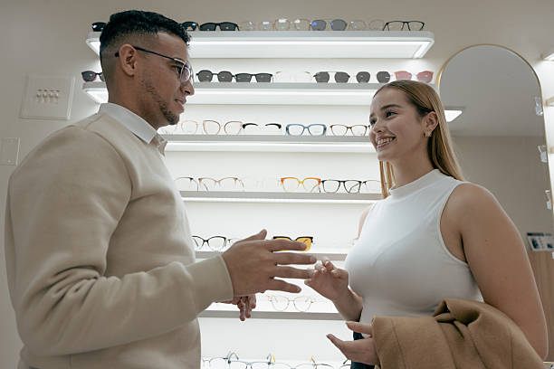 istock Friendly interaction between customer and optician at small eyewear boutique 2217567459