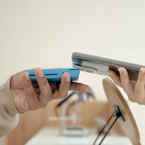 istock Customer makes a payment with smartphone on portable card reader. Small business concept, technology and consumerism. Fast and modern shopping experience. 2217567483