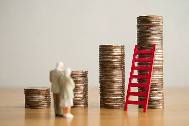 istock Old senior couple person standing looking at growth stack coins graph chart and red ladder. 2217568929