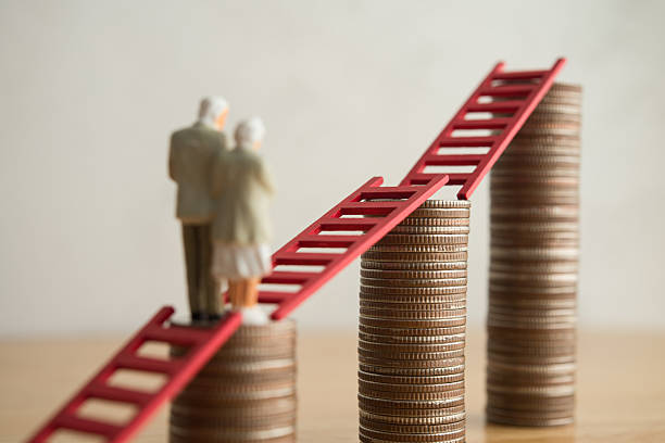 istock Old senior couple person walking on growth stack coins graph chart with red ladder. 2217568931
