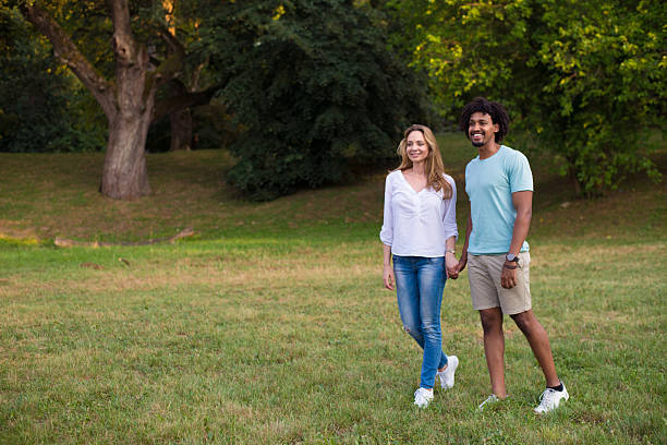 Interracial couple walking in the nature on a sunny summer day