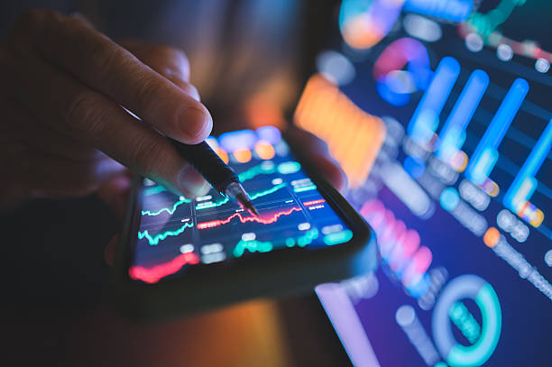 istock Hand interacting with financial app displaying volatile stock chart modern business tablet showing market downturn with financial data and candlestick analysis 2217570995
