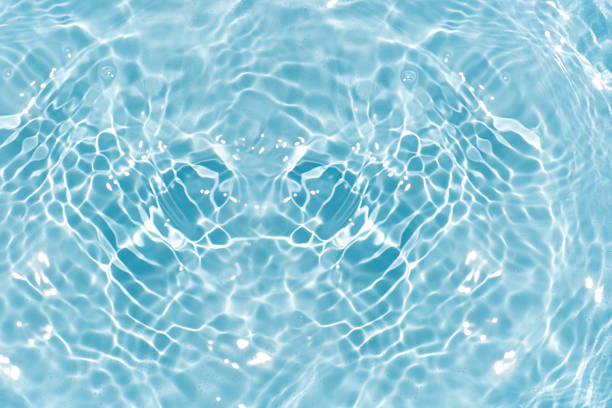 istock Blue water with ripples on the surface. Defocus blurred transparent blue colored clear calm water surface texture with splashes and bubbles. Water waves with shining pattern texture background. 2217571603