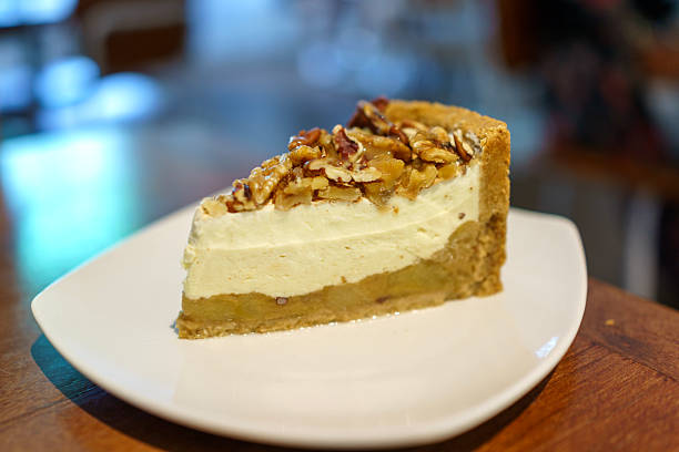 Salted Caramel Apple Cheesecake Slice with Nut Topping on White Plate