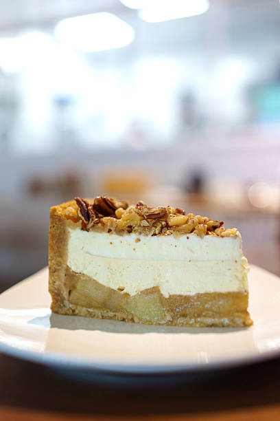 Salted Caramel Apple Cheesecake Slice with Nut Topping on White Plate