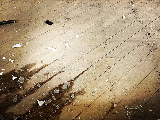 istock Weathered Wood Floor with Broken Glass 2217572080
