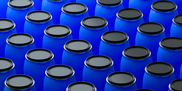 A clean, modern 3D render of numerous blue industrial barrels arranged in a neat, repeating pattern. This image is an excellent visual metaphor for mass production, industrial storage, supply chain logistics, and the chemical industry. The uniform arrangement creates a strong graphic background suitable for corporate presentations, industry reports, and websites related to manufacturing and large-scale distribution.