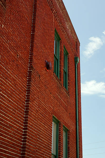 istock Perspective View of an old Red Brick Building With Green Windows 2217576309