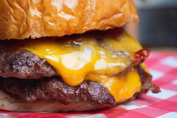 Classic grilled hamburger stacked with juicy beef, cheddar cheese, and toasted brioche bun.