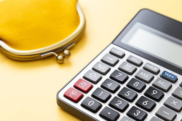 istock Calculator and wallet on a yellow background. 2217579135