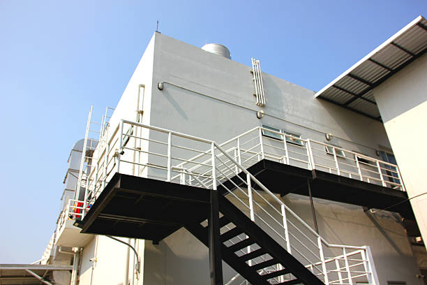 low angle view steel structure walkway install out side building to ground floor. emergency exit fire  steel stairs walkwaty outside the building as per the control law
