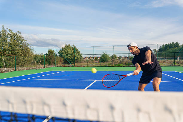 istock Tennis player performing backhand stroke during match on blue court 2217584312