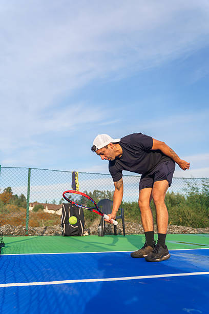 istock Tennis player preparing to serve on a sunny day 2217584330
