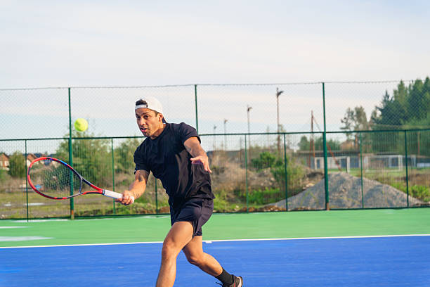 istock Tennis player performing forehand swing on a sunny day 2217584344