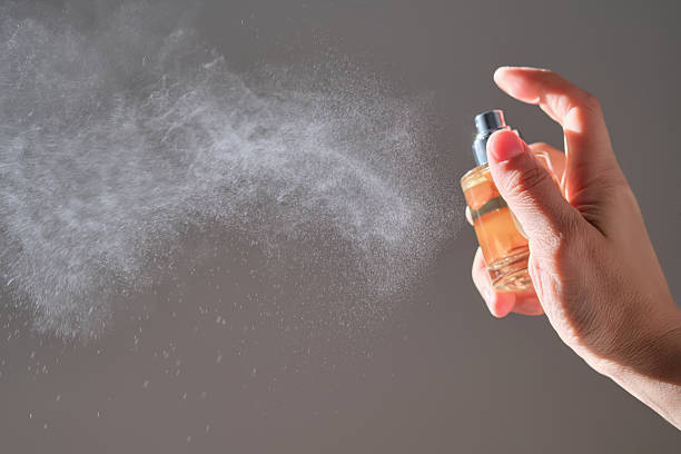 istock The hand sprays perfume from a transparent rounded bottle. 2217586848